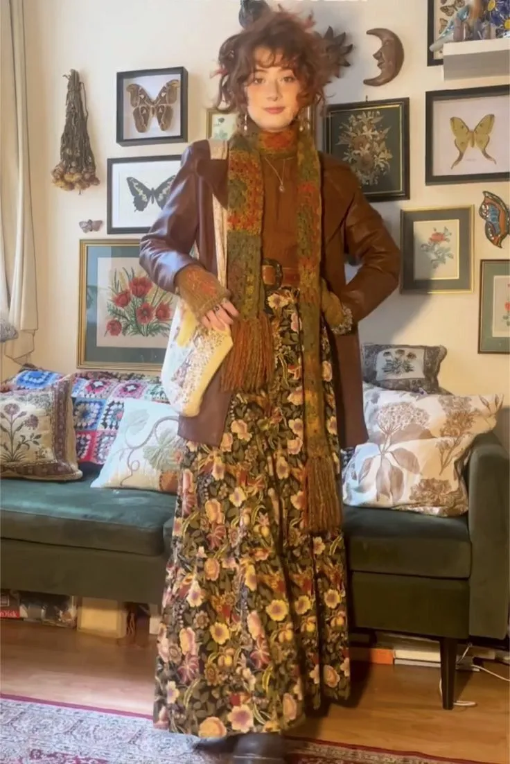 Autumn Aesthetic aesthetic — The outfit strongly embodies the 'harvest-and-fallen-leaf palette' with its rust, burnt orange, and deep green tones in the scarf and dress, and features signature garments like a suede jacket and chunky knit scarf, aligning well with the 'cinnamon girl' adjacent aesthetic.