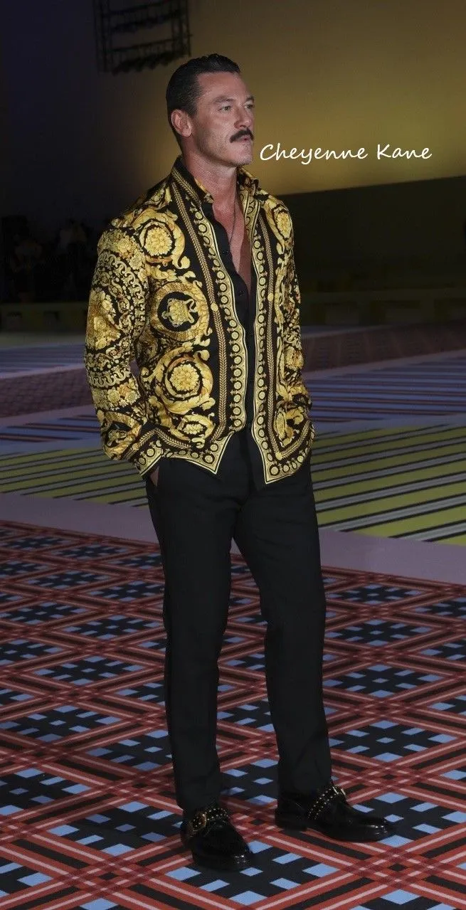 Buchón aesthetic — The iconic Versace baroque print shirt is the most direct and powerful visual cue for the Buchón aesthetic.