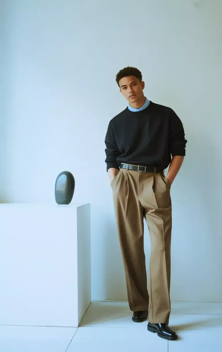 Business Casual aesthetic — Chinos, a collared shirt layered under a sweater, and polished shoes with a belt are signature elements of the business casual aesthetic.