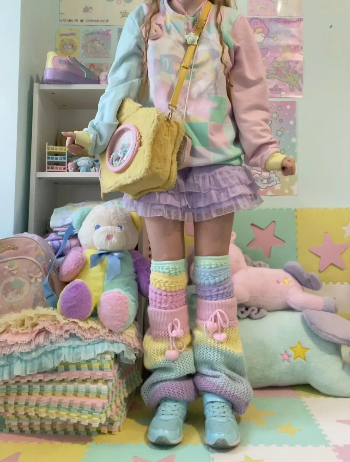 Fairy Kei aesthetic — The combination of a pastel tulle skirt, oversized pastel sweater with graphics, and platform sneakers perfectly matches the description.