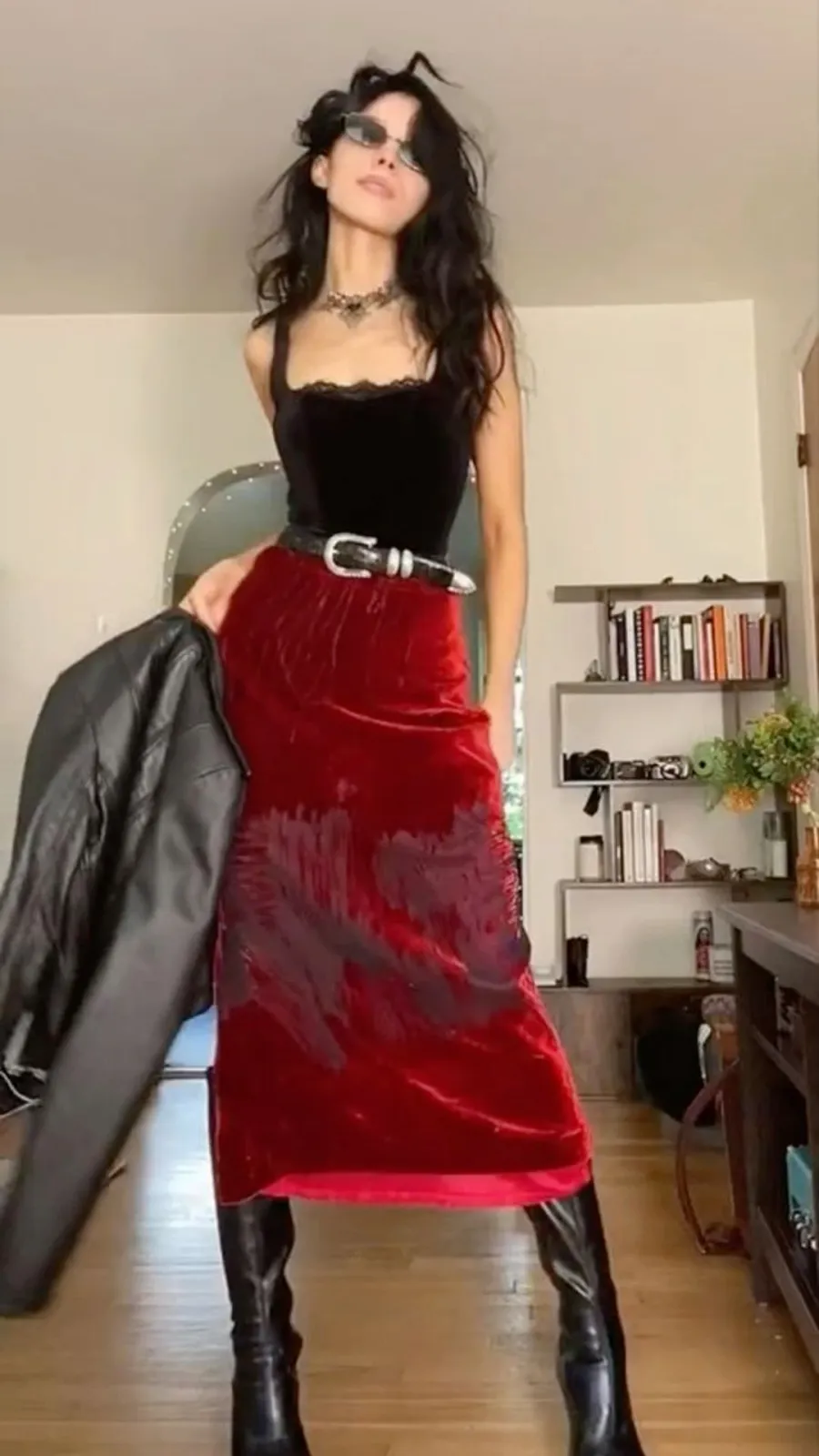 Femme Fatale aesthetic — The fitted velvet dress in a dark red, paired with black boots and a leather jacket, strongly aligns with the description's signature garments, fabrics, and dark palette.