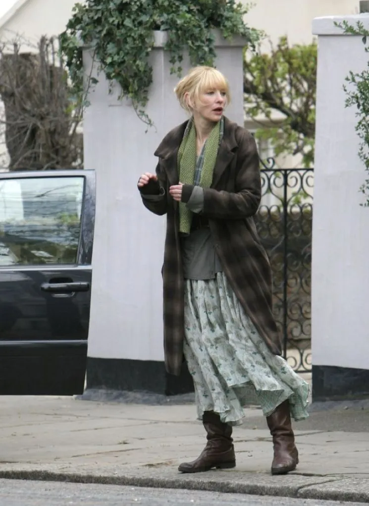 Frazzled English Woman aesthetic — This image directly references Keira Knightley in Love Actually, with the plaid coat, scarf, and slightly dishevelled hair, perfectly embodying the 'Frazzled English Woman' aesthetic.