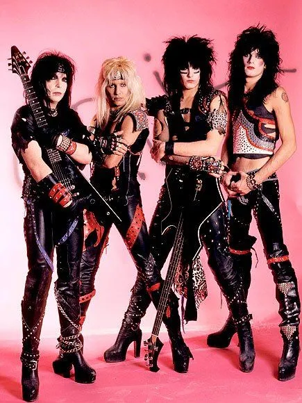 Hair Metal aesthetic — This is a canonical representation of the Hair Metal aesthetic with its leather, studs, ripped denim, teased hair, and band imagery.