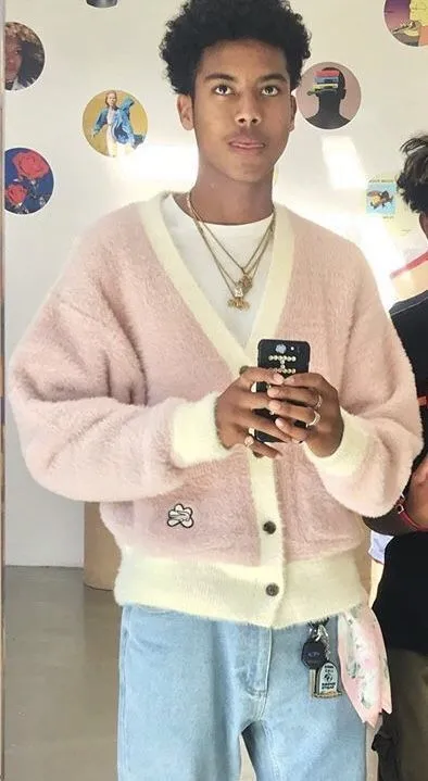 Kkonminam (Flower Boy) aesthetic — The pastel pink fluffy cardigan with cream trim, paired with light wash jeans and minimal jewelry, is an almost perfect embodiment of the Kkonminam aesthetic, especially the 'flower boy' aspect.