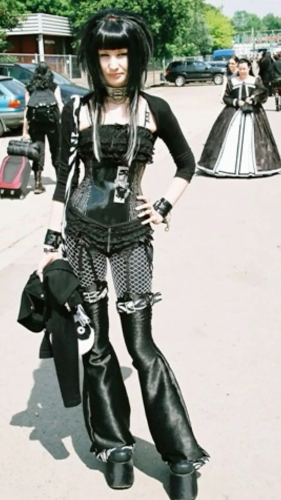Mall Goth aesthetic — This image is a textbook example of Mall Goth, featuring a corset, spiked choker, plaid elements, and platform boots, aligning perfectly with the description's visual signature.