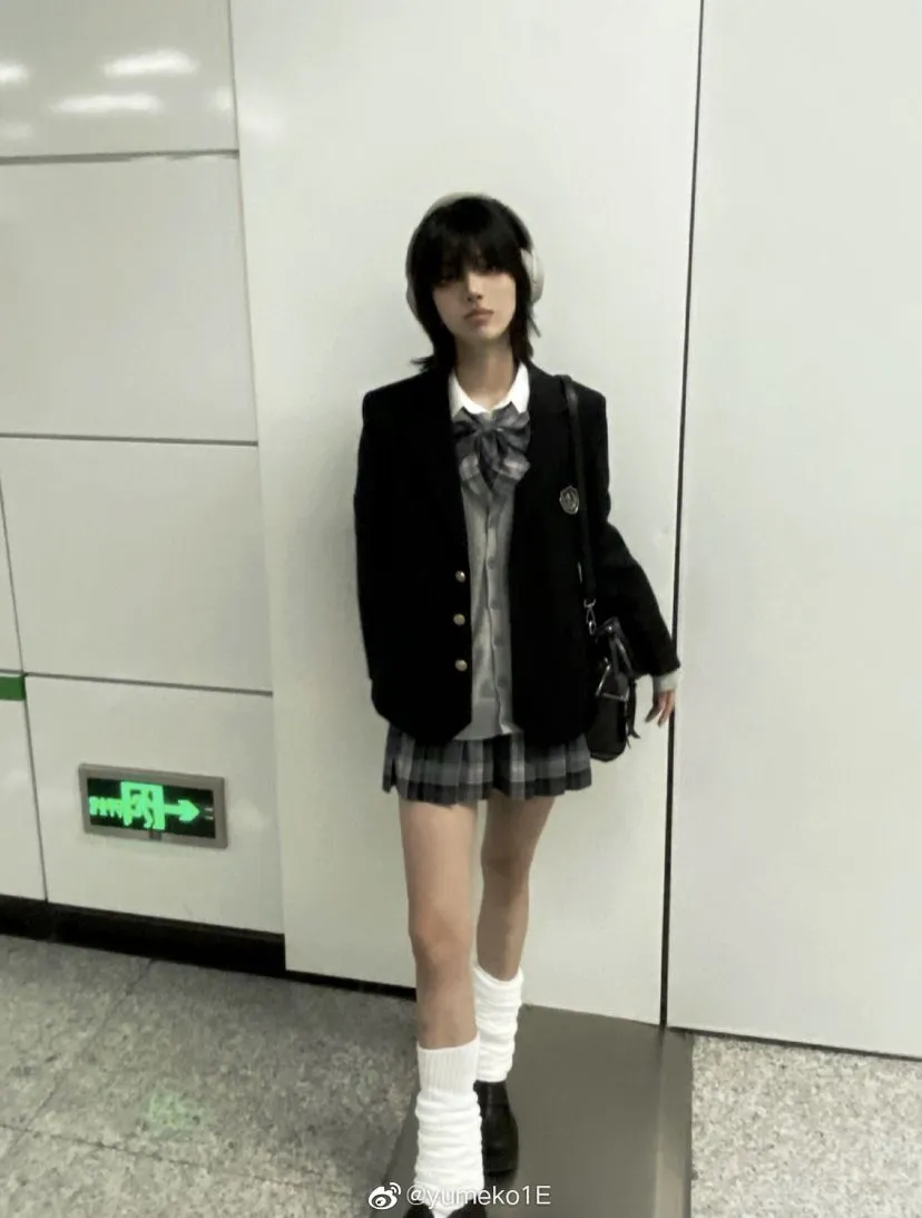 Nanchatte Seifuku aesthetic — The navy blazer, plaid skirt, white blouse with tie, and knee-high socks are textbook Nanchatte Seifuku, embodying the 'assembled non-uniform schoolgirl look'.
