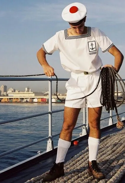 Nautical aesthetic — Features a classic sailor's uniform with Breton stripes, anchor motif, sailor cap, and rope, hitting all key visual signatures.