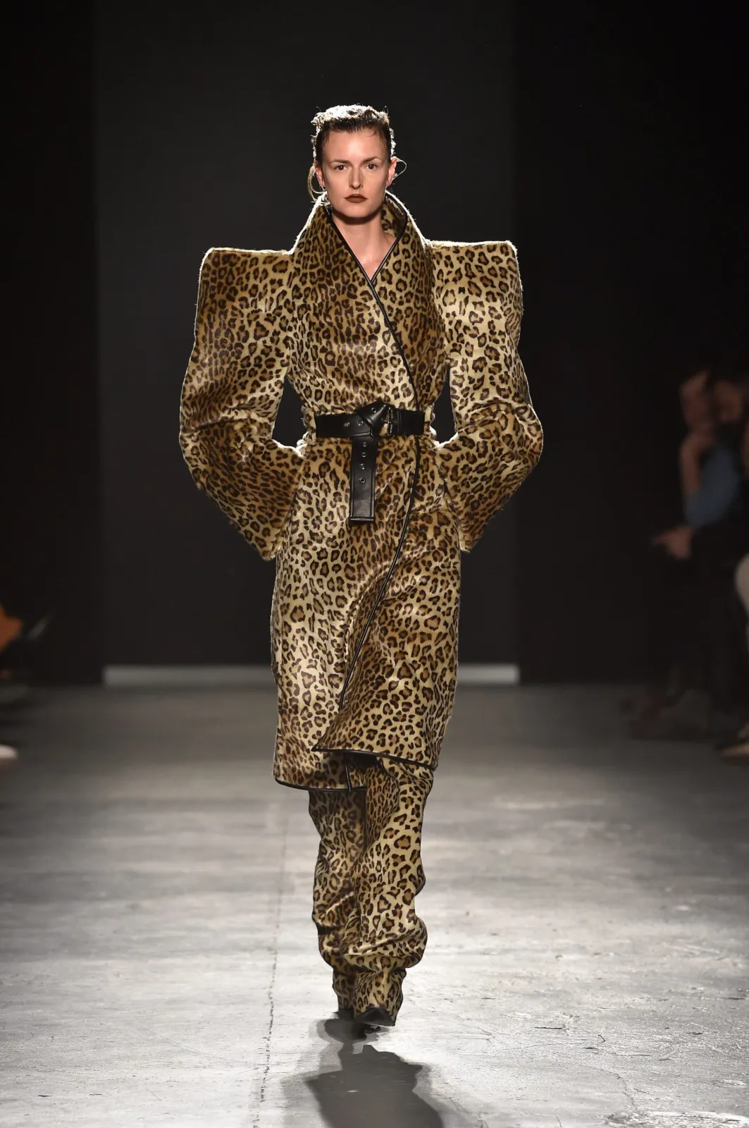 Power Dressing aesthetic — Exaggerated shoulder pads and bold animal print on a structured suit evoke the dramatic tailoring and assertive palette of the era.