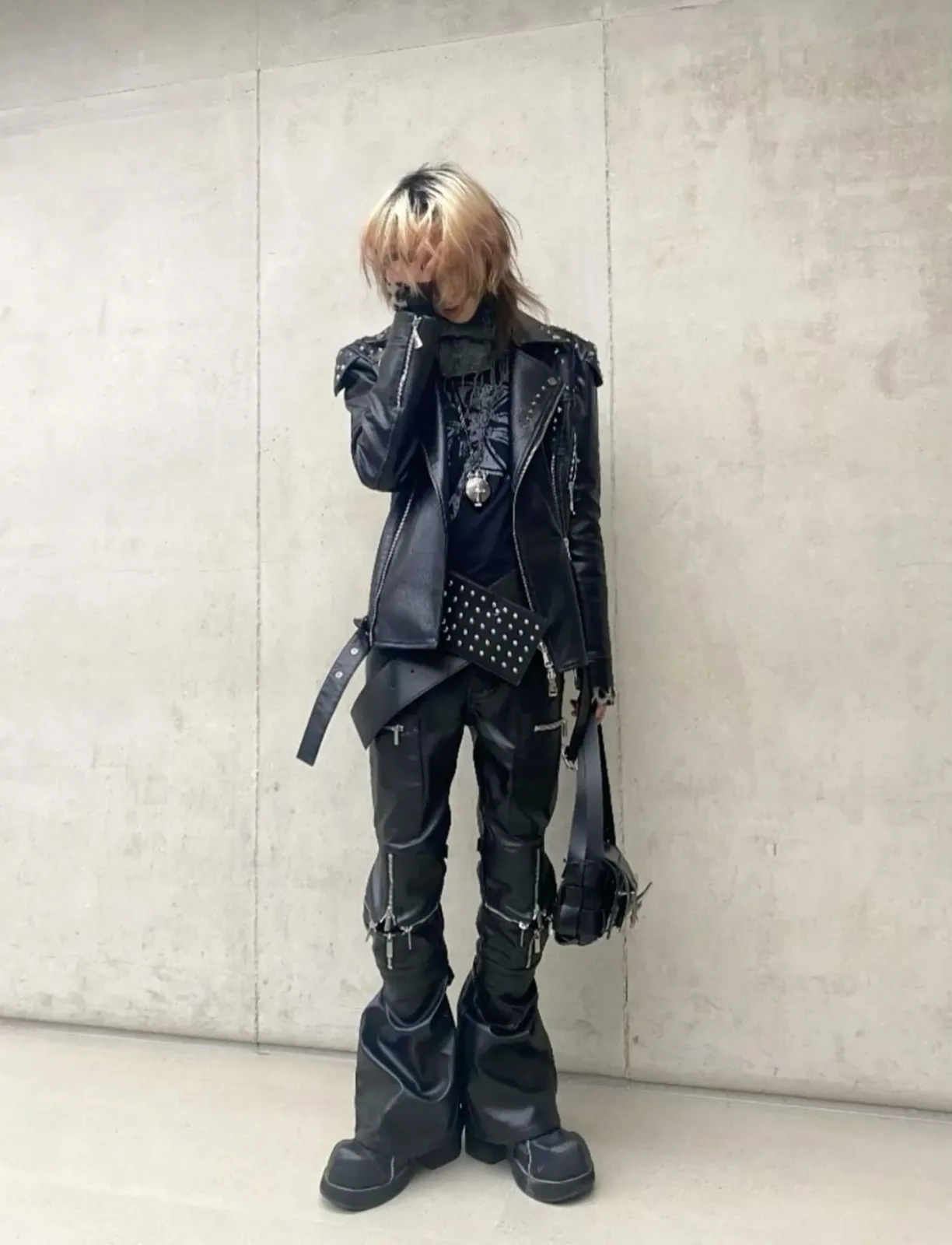 Sigilkore aesthetic — The all-black leather outfit with zippers, studded belt, and chunky boots strongly evokes the occult-streetwear and dark aesthetic described.