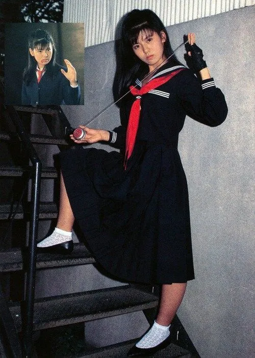 Sukeban aesthetic — Classic Sukeban look with modified sailor uniform, long pleated skirt, and rolled-down socks, evoking the 1970s era.