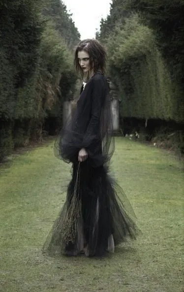Witch House aesthetic — The all-black, draped mesh layers and gothic silhouette are highly representative of Witch House fashion, particularly the 'Nu Goth' influence.