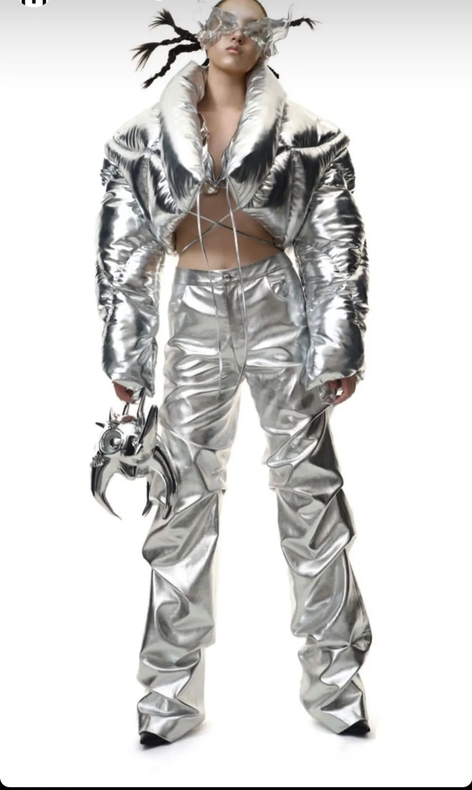 Y2K Cyber aesthetic — The metallic puffer jacket, ruched vinyl trousers, and avant-garde accessories perfectly embody the Y2K Cyber futurism described.